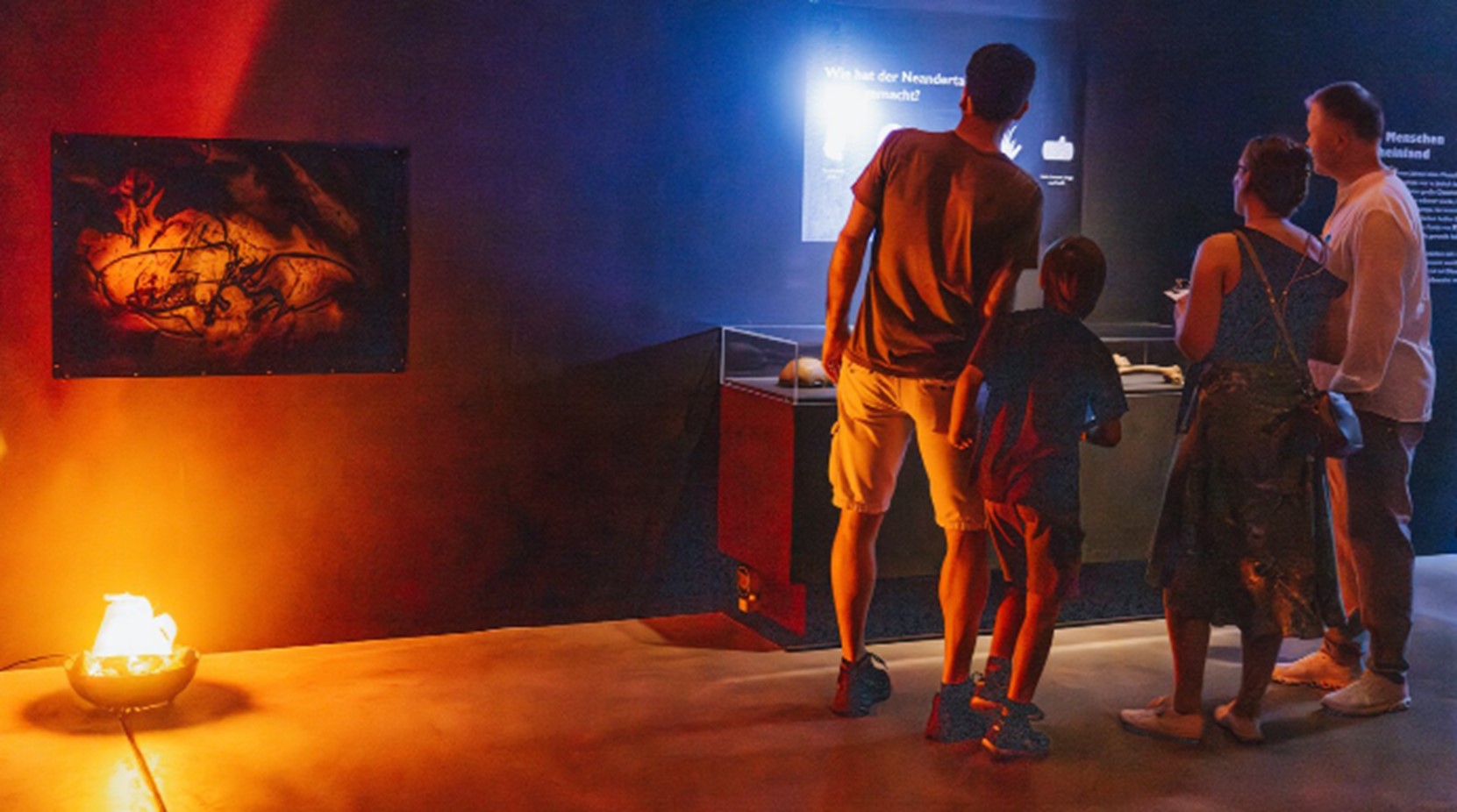 Nachtwache Escape Game im Landesmuseum Bonn, Familie im dunklen Museumsraum vor dem Neandertaler